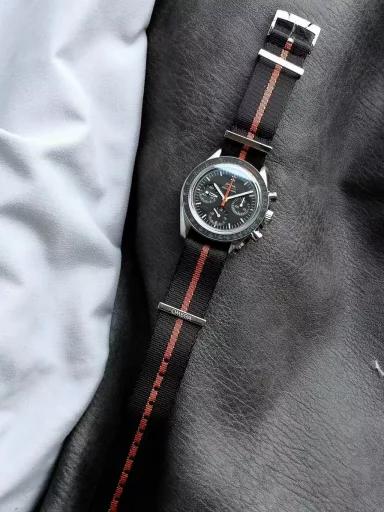 OM recommends: Omega Speedmaster 311.12.42.30.01.001 watch, stainless steel case, black anodized aluminum dial with orange elements, including the origin on the minute circle, the first 3 minutes of the small dial at 3 o'clock, and the famous 