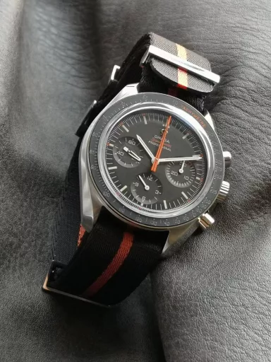 OM recommends: Omega Speedmaster 311.12.42.30.01.001 watch, stainless steel case, black anodized aluminum dial with orange elements, including the origin on the minute circle, the first 3 minutes of the small dial at 3 o'clock, and the famous 