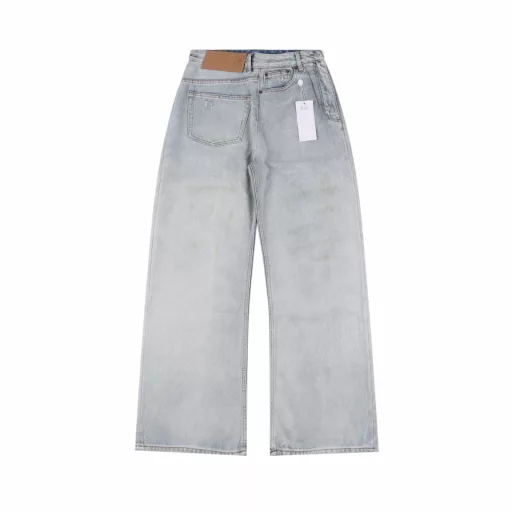 Margiela MM6 patch distressed denim trousersCustomized denim rough twill cotton satin, combined with rubbing and pressing cat whisker technology and gun painting cat whisker technology, manual rubbing is preferred in specific areas to achieve natural wrinkle effects, and then specific tools are used to draw cat whisker-shaped textures to maximize visual effects, the holes are made with rotten edge hanging rotten technology, and the natural rotten edge effect is achieved by rubbing the edges through physical wear, and the fiber hairiness and color difference are removed through the combination of high-temperature steam and sandpaper, so that the jeans present unique holes and wear effects, heavy washing and spraying dirty process, through physical and chemical means, use a spray gun to evenly spray water-soluble dyes on the denim fabric, the dye will form natural spots and stains on the surface of the fabric, simulating the wear marks after long-term wear, customized accessories, loose version