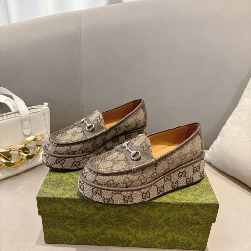 ucci new women's wedge loafers horsebit moccasin Original GG fabric sets this sophisticated horsebit moccasin apart. Black cowhide light gold metal details. The wedge heel brings an original and impactful touch to this iconic style