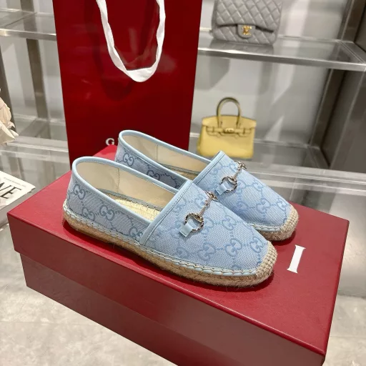 Horsebit Women's New Fisherman ShoesCrafted in off-white GG canvas, these shoes combine traditional patterns with modern style. The light gold horsebit detail adds a touch of sophistication, while the cotton, linen and rubber sole ensures comfort and stability.