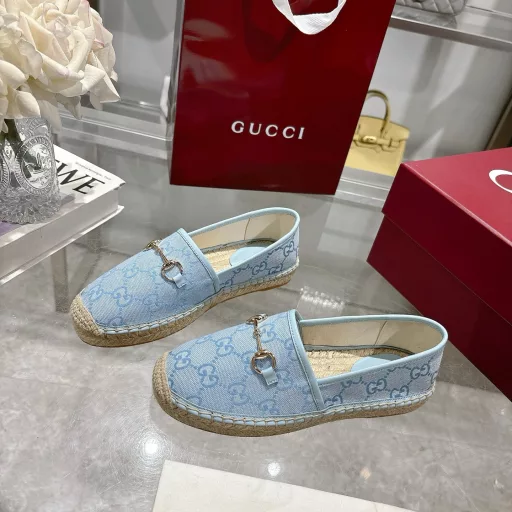 Horsebit Women's New Fisherman ShoesCrafted in off-white GG canvas, these shoes combine traditional patterns with modern style. The light gold horsebit detail adds a touch of sophistication, while the cotton, linen and rubber sole ensures comfort and stability.