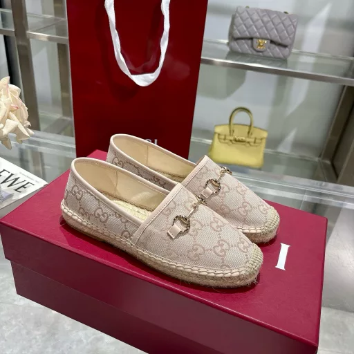 Horsebit Women's New Fisherman ShoesCrafted in off-white GG canvas, these shoes combine traditional patterns with modern style. The light gold horsebit detail adds a touch of sophistication, while the cotton, linen and rubber sole ensures comfort and stability.