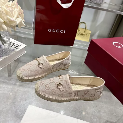Horsebit Women's New Fisherman ShoesCrafted in off-white GG canvas, these shoes combine traditional patterns with modern style. The light gold horsebit detail adds a touch of sophistication, while the cotton, linen and rubber sole ensures comfort and stability.