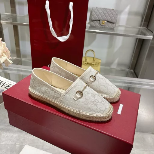 Horsebit Women's New Fisherman ShoesCrafted in off-white GG canvas, these shoes combine traditional patterns with modern style. The light gold horsebit detail adds a touch of sophistication, while the cotton, linen and rubber sole ensures comfort and stability.