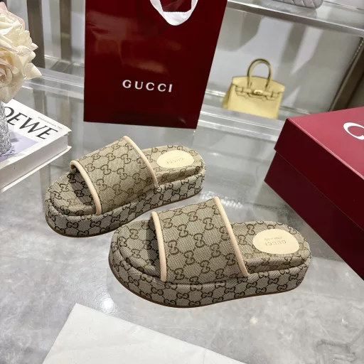 2025 Women's New GG Platform Slide SandalsThe iconic Gucci logo and sophisticated patterns are reinterpreted in a contemporary way for the latest Gucci collection. Made from GG canvas, these wedge-shaped slide sandals feature an iconic silhouette.Original GG canvas in beige and light apricot
