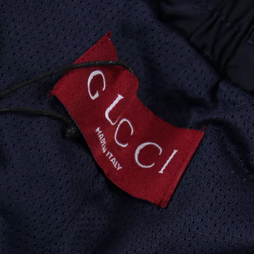 Gucci GG full print monogram embroidered shortsInterlocking double G print, drawstring elastic waistband, straight shorts style, full set of accessories! Polyester fiber is a blended fabric, contrasting fabric is fixed color and environmentally friendly. It also has good light resistance, and its sun resistance is better than natural fiber fabrics. It uses three-level bird's eye cloth fabric, which is a functional weft knitted fabric with moisture absorption and perspiration function. The principle of perspiration is through the small holes on its surface. Due to the existence of these small holes, it can achieve the effect of moisture absorption and perspiration. The double G pattern is made of thick glue material, and the glue is specially adjusted with environmentally friendly glue. The front end of the elastic waist rope has an engraved hardware bell, the front trouser line is stitched, and the trouser legs are closed with visible lines, which are strong and durable.