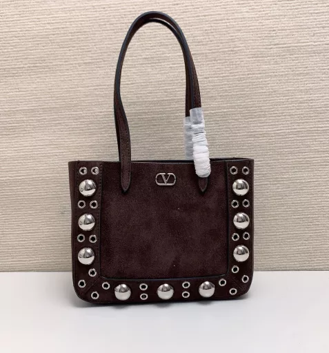 Small GARAVANI NELLCÔTE calfskin bag with ball studs and circular cutouts.