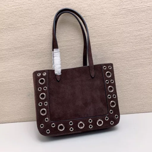 Small GARAVANI NELLCÔTE calfskin bag with ball studs and circular cutouts.