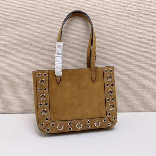 Small GARAVANI NELLCÔTE calfskin bag with ball studs and circular cutouts.