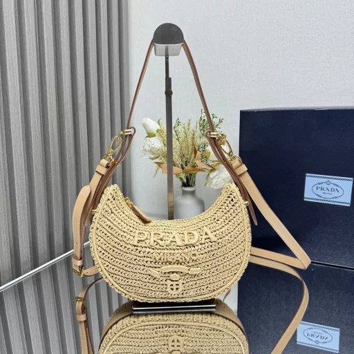 New Woven Moon Bag: Featuring a curvaceous half-moon silhouette, the raffia fabric gives it structure and uniqueness. Reinterpreted with a more refined design, full of summer mood, cleverly adding details such as handles and detachable shoulder straps, it can be worn in a variety of styles