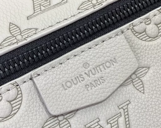 The sporty silhouette is enhanced with Monogram Shadow embossed leather and sophisticated hardware, and the flap is decorated with zipper pockets above and below. The adjustable fabric shoulder strap allows for shoulder or crossbody carry.