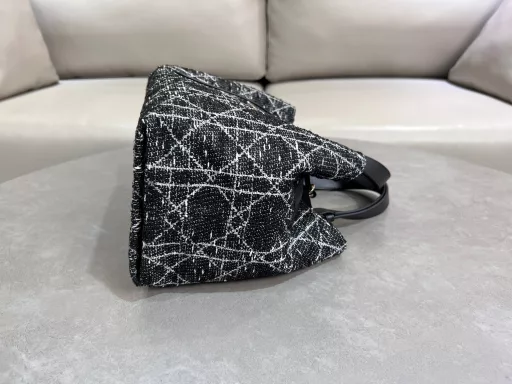 The Dior Toujours bag is casual and practical, with a twist. Crafted from calfskin leather with oversized cannage stitching and black calfskin details, it features a spacious interior with matching pouches to neatly organize your daily essentials. It has a slim leather tie closure to keep everything secure, and a CD Lock D knob clasp that adjusts the sides for added style. Medium size with leather top handle with adjustable details for hand or shoulder carry