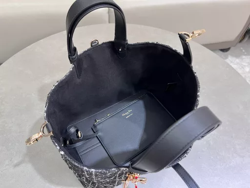 The Dior Toujours bag is casual and practical, with a twist. Crafted from calfskin leather with oversized cannage stitching and black calfskin details, it features a spacious interior with matching pouches to neatly organize your daily essentials. It has a slim leather tie closure to keep everything secure, and a CD Lock D knob clasp that adjusts the sides for added style. Medium size with leather top handle with adjustable details for hand or shoulder carry