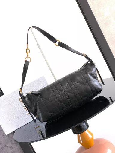 New this season, the D-Journey bag made its debut at the Dior Spring/Summer 2025 ready-to-wear show. It's soft and modern, with a modern take on the dumpling bag silhouette. Crafted from white crinkled calfskin leather, it's decorated with flat, oversized rattan stitching, a new take on Dior's classic motif. The main compartment features a zippered pocket for added refinement, and two decorative side pockets with large leather zipper pulls embellished with the Christian Dior Paris logo. The medium size, with an adjustable top leather handle and leather shoulder strap, can be carried by hand, on the shoulder or across the body, making it an ideal companion for everyday styling