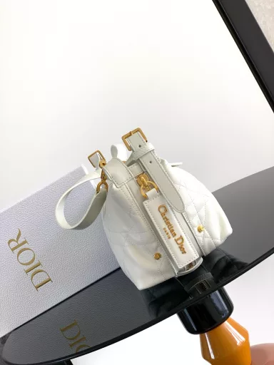 New this season, the D-Journey bag made its debut at the Dior Spring/Summer 2025 ready-to-wear show. It's soft and modern, with a modern take on the dumpling bag silhouette. Crafted from white crinkled calfskin leather, it's decorated with flat, oversized rattan stitching, a new take on Dior's classic motif. The main compartment features a zippered pocket for added refinement, and two decorative side pockets with large leather zipper pulls embellished with the Christian Dior Paris logo. The medium size, with an adjustable top leather handle and leather shoulder strap, can be carried by hand, on the shoulder or across the body, making it an ideal companion for everyday styling