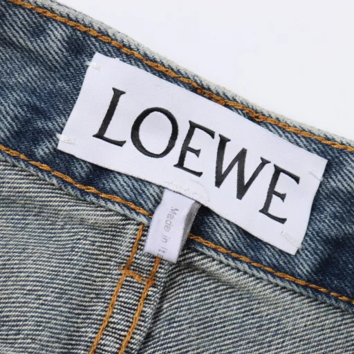 Loewe Anagram tapered denim pantsCustomized elegant rough twill denim material, laser laser technology, using high-energy laser beam to accurately process the material surface, by controlling the intensity, frequency and scanning speed of the laser beam, high-precision Loewe Anagram engraving can be achieved, using sand frying hand rubbing technology, through processing on the sand frying machine, the surface of the jeans will fade and wear naturally, and then the surface of the jeans will be physically damaged by hand using special tools, maintaining the original texture and details while increasing its uniqueness, heavy washing and whitening process, through physical and chemical means, the denim fabric is deeply processed multiple times, so that the surface of the pants presents a gray effect, and then the denim fabric is polished by machine to make the surface of the pants have a worn effect, customized accessories, fit version