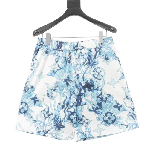Louis Vuitton Coral Seaweed Shorts Made from silk, this fresh short-sleeved shirt features the collection's Monogram Aquagarden pattern, with coral and seaweed leaves and aqua tones complemented by embroidered sequins. Made from lightweight silk, this casual piece has a lively silhouette and an open collar in contrasting white. It's a graphic holiday wardrobe piece that can be easily paired with timeless summer pieces. Ready to plunge into the ocean, these fresh swim shorts feature the Monogram Aquagarden graphic pattern in aqua tones. The all-over logo printed on technical nylon combines coral and seaweed leaves with subtle Monogram elements. Coming out of the water, this piece completes your summer vacation look