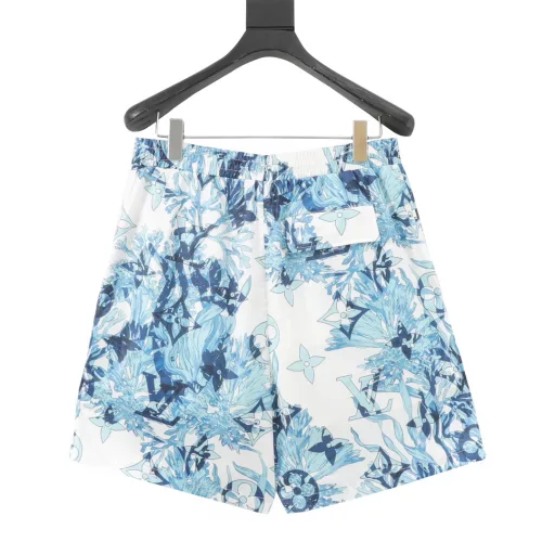 Louis Vuitton Coral Seaweed Shorts Made from silk, this fresh short-sleeved shirt features the collection's Monogram Aquagarden pattern, with coral and seaweed leaves and aqua tones complemented by embroidered sequins. Made from lightweight silk, this casual piece has a lively silhouette and an open collar in contrasting white. It's a graphic holiday wardrobe piece that can be easily paired with timeless summer pieces. Ready to plunge into the ocean, these fresh swim shorts feature the Monogram Aquagarden graphic pattern in aqua tones. The all-over logo printed on technical nylon combines coral and seaweed leaves with subtle Monogram elements. Coming out of the water, this piece completes your summer vacation look