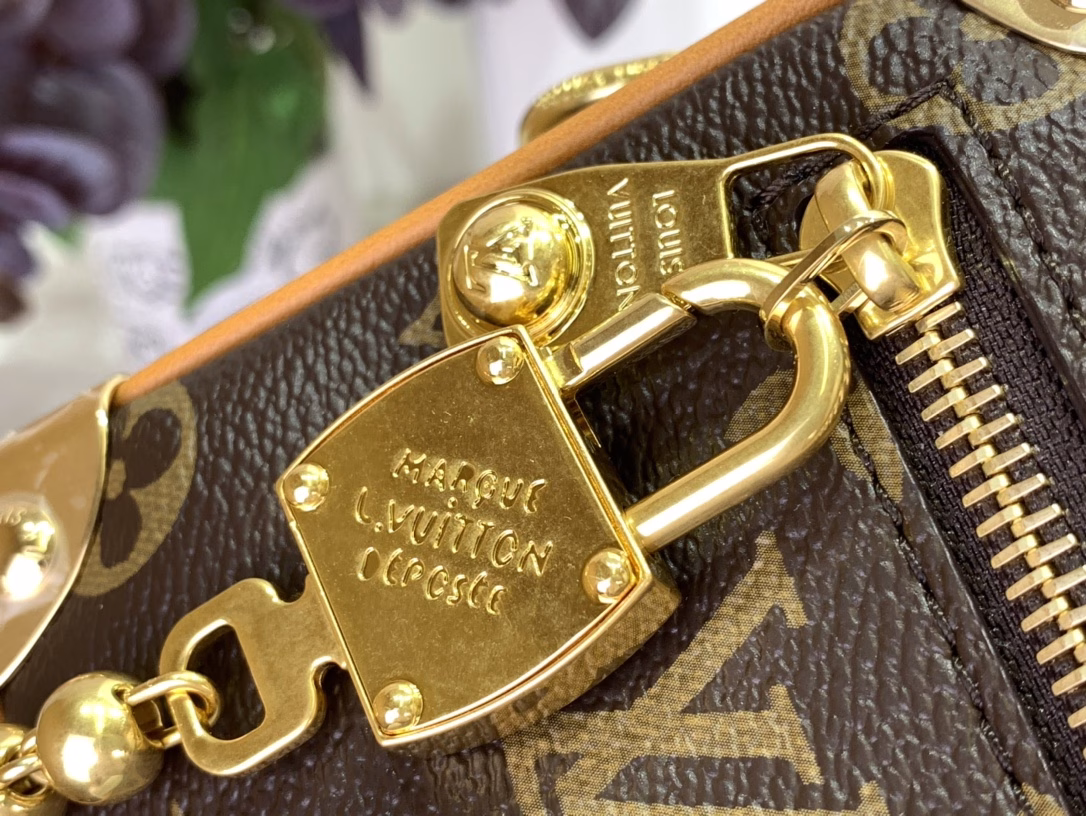The mini soft luggage is made of Monogram coated canvas with natural cowhide leather trim. It features a gold ball chain and a new decorative padlock engraved with the 