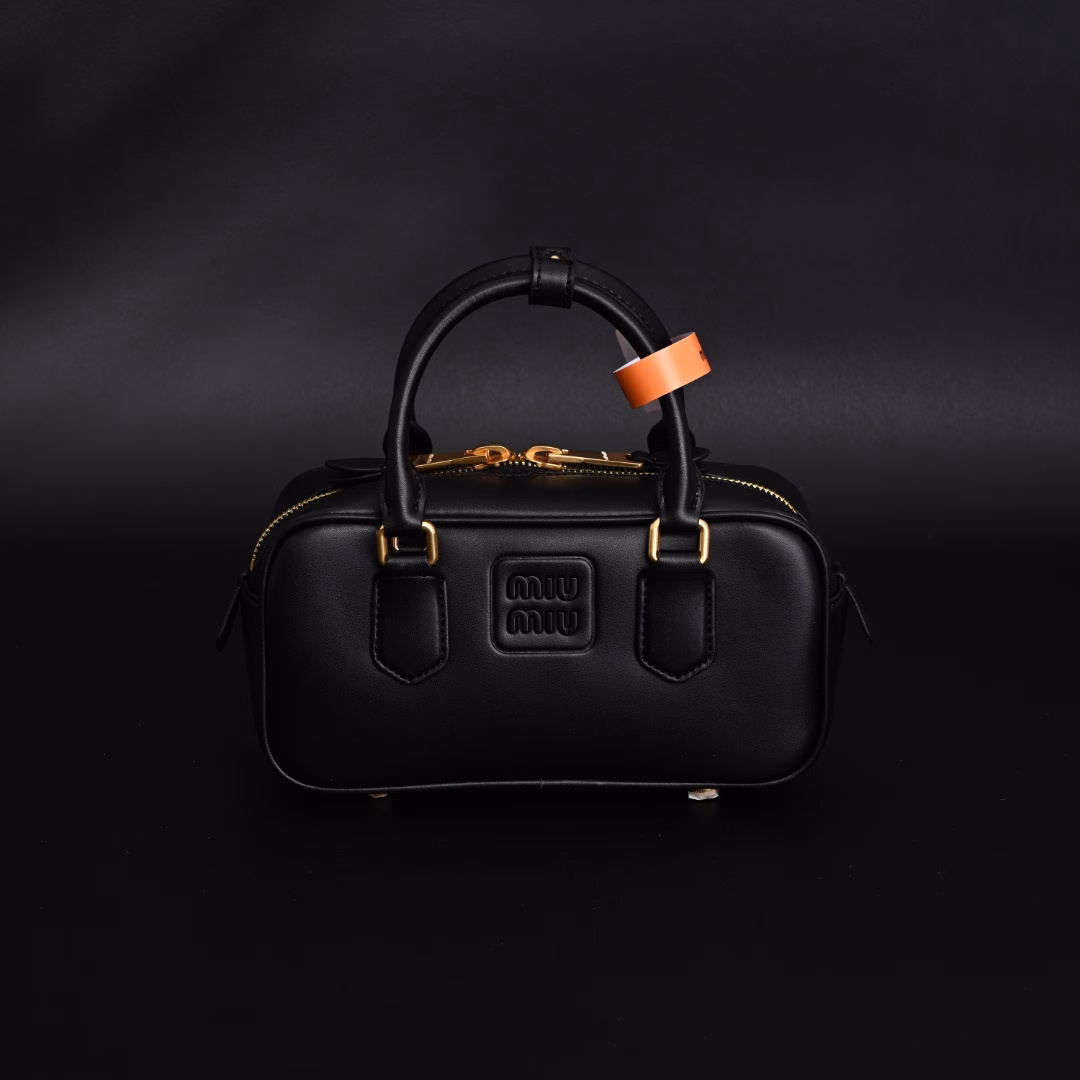 Miu Miu Bowling BriefcaseThe bag is just the right amount of sweetness!It's hard not to love it!Can be carried by hand or worn cross-bodyIt's definitely not a small bag! It has plenty of space~~It's the little princess Miu Miu!
