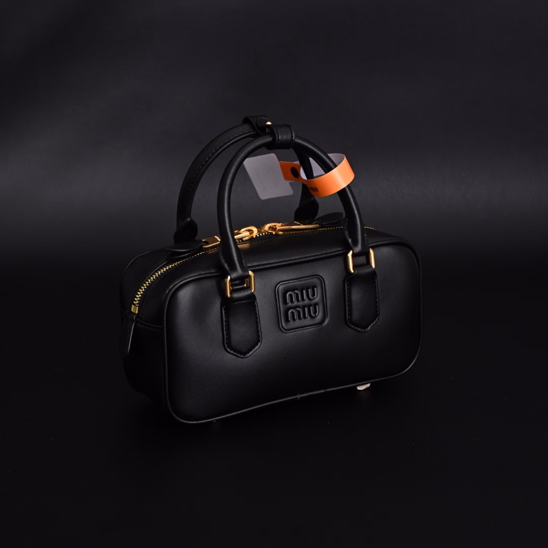 Miu Miu Bowling BriefcaseThe bag is just the right amount of sweetness!It's hard not to love it!Can be carried by hand or worn cross-bodyIt's definitely not a small bag! It has plenty of space~~It's the little princess Miu Miu!