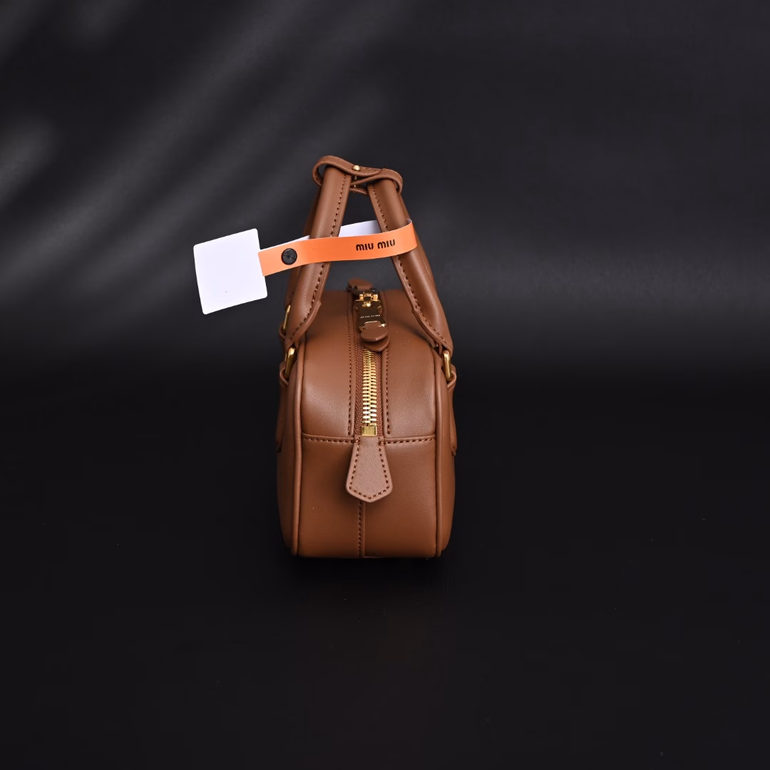 Miu Miu Bowling BriefcaseThe bag is just the right amount of sweetness!It's hard not to love it!Can be carried by hand or worn cross-bodyIt's definitely not a small bag! It has plenty of space~~It's the little princess Miu Miu!