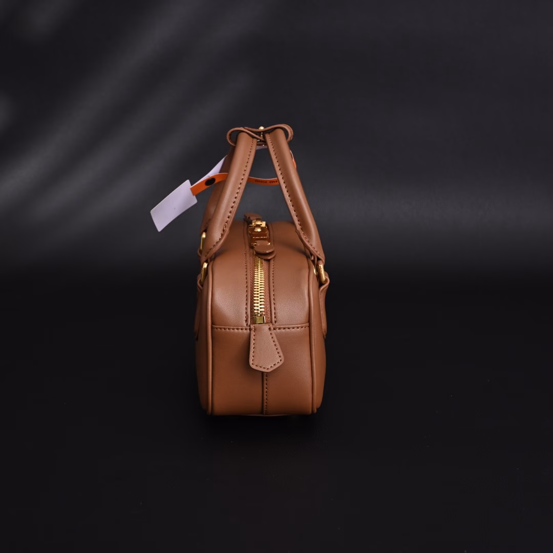 Miu Miu Bowling BriefcaseThe bag is just the right amount of sweetness!It's hard not to love it!Can be carried by hand or worn cross-bodyIt's definitely not a small bag! It has plenty of space~~It's the little princess Miu Miu!