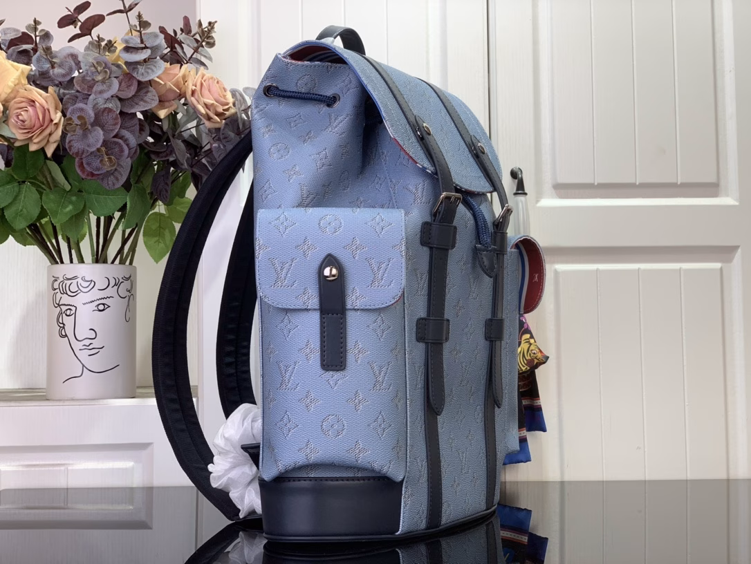 The Christopher Medium Backpack is a nod to sailing and ocean liners, with Monogram Heritage coated canvas dyed in a new hue. The leather outlines the handsome silhouette, the buckle fastens the vertical straps, and the spacious structure is lined with striped fabric.
