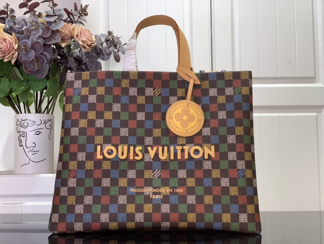 The Shopper Tote is inspired by the classic Louis Vuitton shopping bag, featuring the same clean lines and contrasting Louis Vuitton monogram. This bag is made of LVers Damier Ebene coated canvas with Pharrell Williams' colorful reinterpretation of the Damier pattern (inspired by the classic design created by Georges Vuitton in 1888). Two top handles and a removable shoulder strap provide flexible carrying options, combining practicality and unique charm.