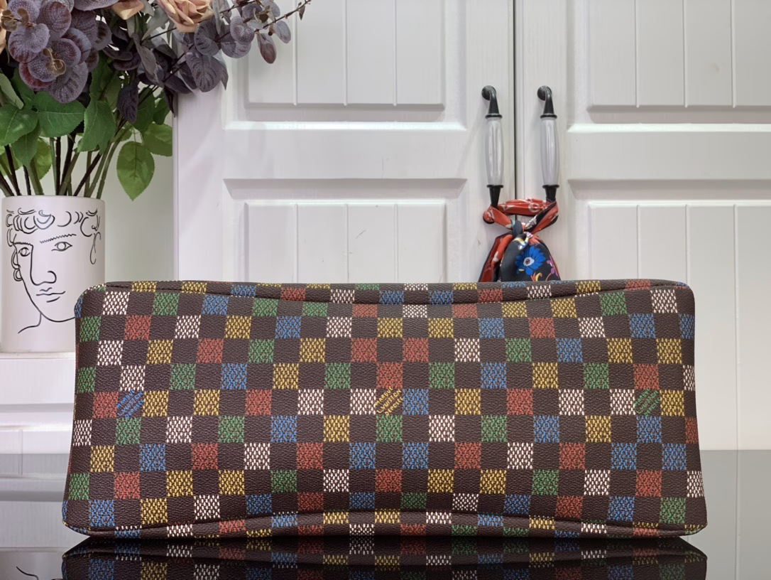 The Shopper Tote is inspired by the classic Louis Vuitton shopping bag, featuring the same clean lines and contrasting Louis Vuitton monogram. This bag is made of LVers Damier Ebene coated canvas with Pharrell Williams' colorful reinterpretation of the Damier pattern (inspired by the classic design created by Georges Vuitton in 1888). Two top handles and a removable shoulder strap provide flexible carrying options, combining practicality and unique charm.