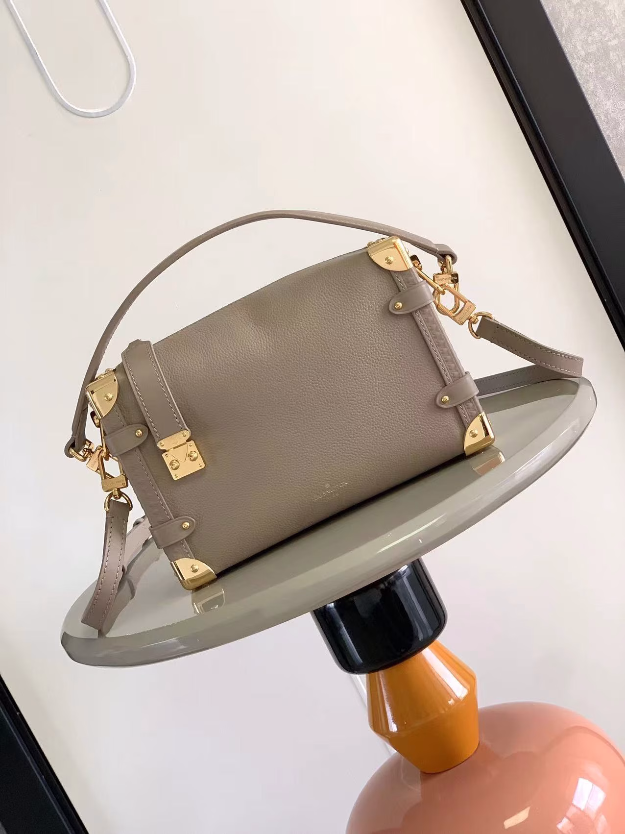 Full leather soft box seriesThis elegant Side Trunk medium handbag pays tribute to the brand's traditional hard case. The grained cowhide body is embellished with smooth cowhide trim, S-lock buckle and metal reinforced corners. The handle and adjustable shoulder strap are both detachable, easy to hold, shoulder or crossbody